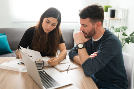 Man and woman going over documents at kitchen table