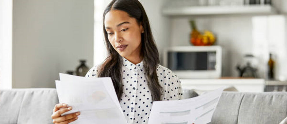 Woman comparing documents in her living room