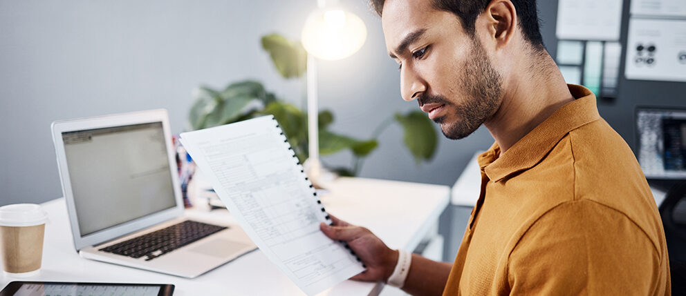 Man reviewing his financial documents in home office