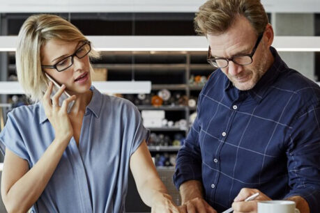 Man and woman couple discussing and reviewing finances in their home