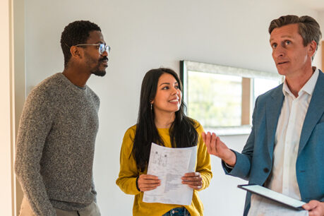 Couple discussing with realtor about house they are touring