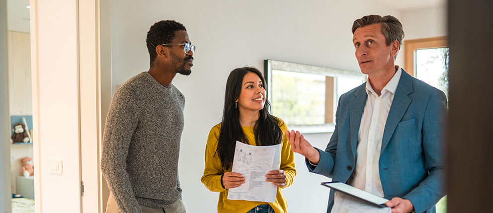 Couple discussing with realtor about house they are touring