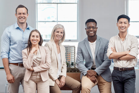 Group of professionals sitting and standing together