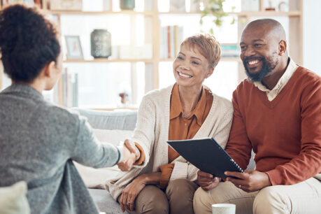 Couple sitting with and discussing with buyer consultant