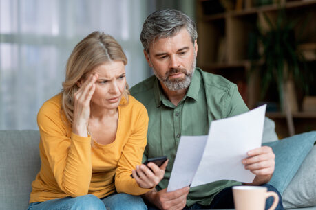 Couple worried while looking at documents