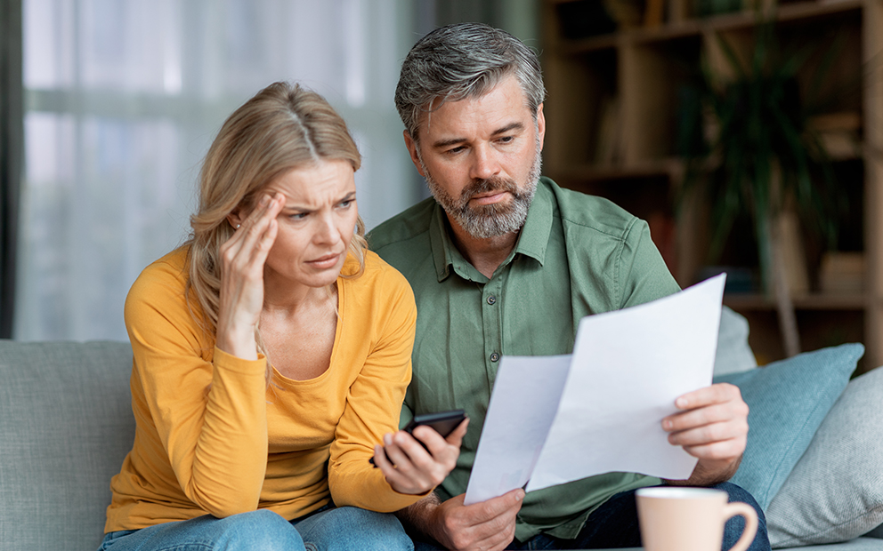 Couple worried while looking at documents