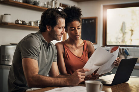 Couple sitting together while reviewing finances