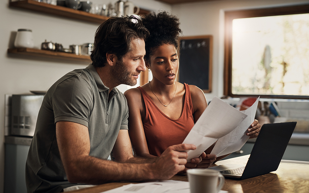 Couple sitting together while reviewing finances