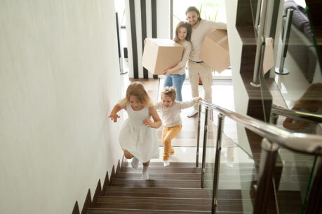 Family running inside their new home