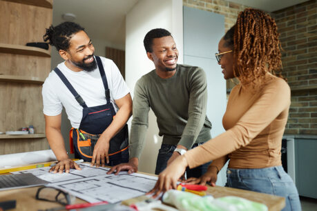 Couple discussing home construction project with builder