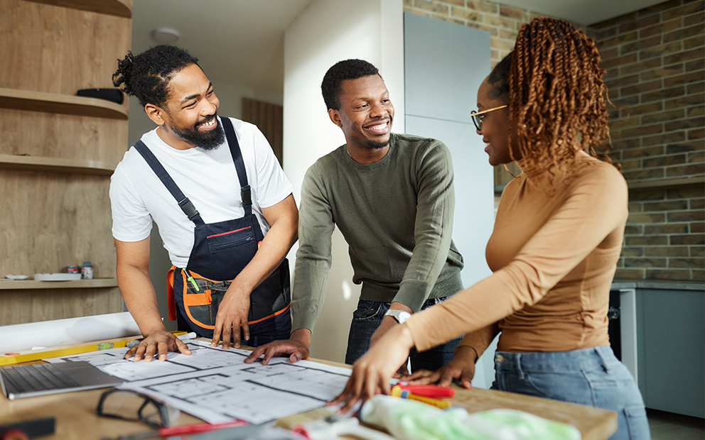 Couple discussing home construction project with builder